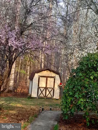 a backyard of a house with a yard and outdoor seating