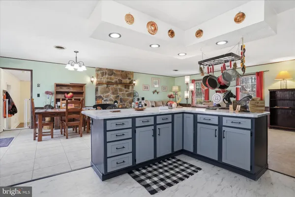 a kitchen with a sink and chairs
