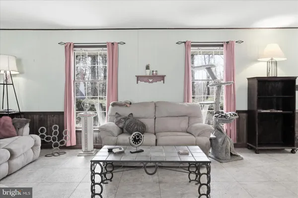 a living room with furniture a lamp and a window