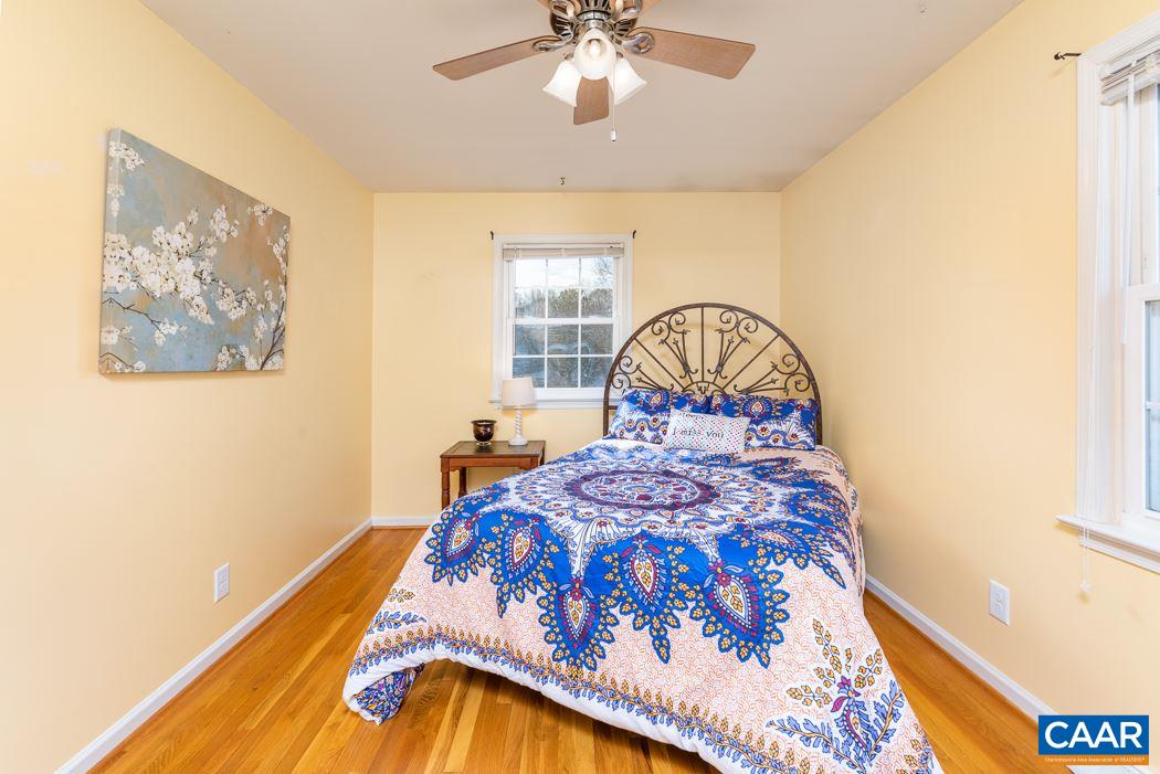 2422 Huntington Road Charlottesville, VA 22901 - Photo 23 of 49 a bedroom with a bed and a chandelier
