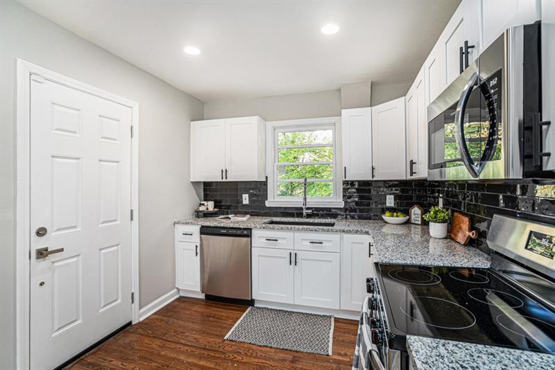 2693 Washington Street Northwest Atlanta, GA 30318 - Photo 11 of 26 a kitchen with a stove a sink and a microwave