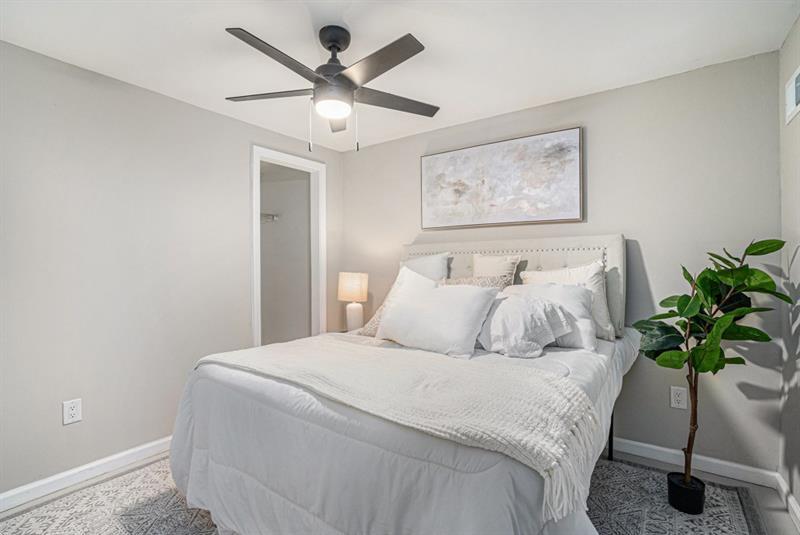 2693 Washington Street Northwest Atlanta, GA 30318 - Photo 18 of 26 a bedroom with a large bed and a potted plant
