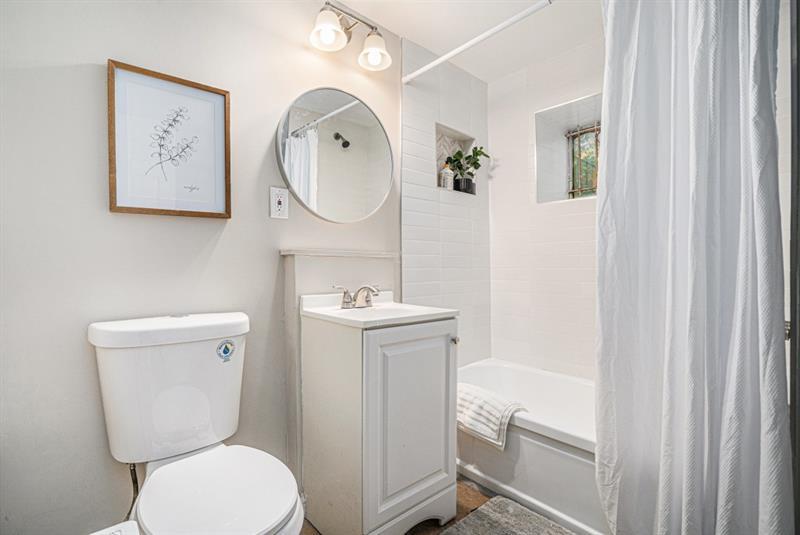 2693 Washington Street Northwest Atlanta, GA 30318 - Photo 19 of 26 a bathroom with a toilet a sink and a mirror