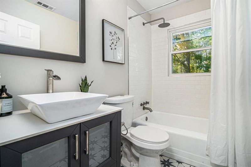 2693 Washington Street Northwest Atlanta, GA 30318 - Photo 5 of 26 a bathroom with a sink a toilet and shower