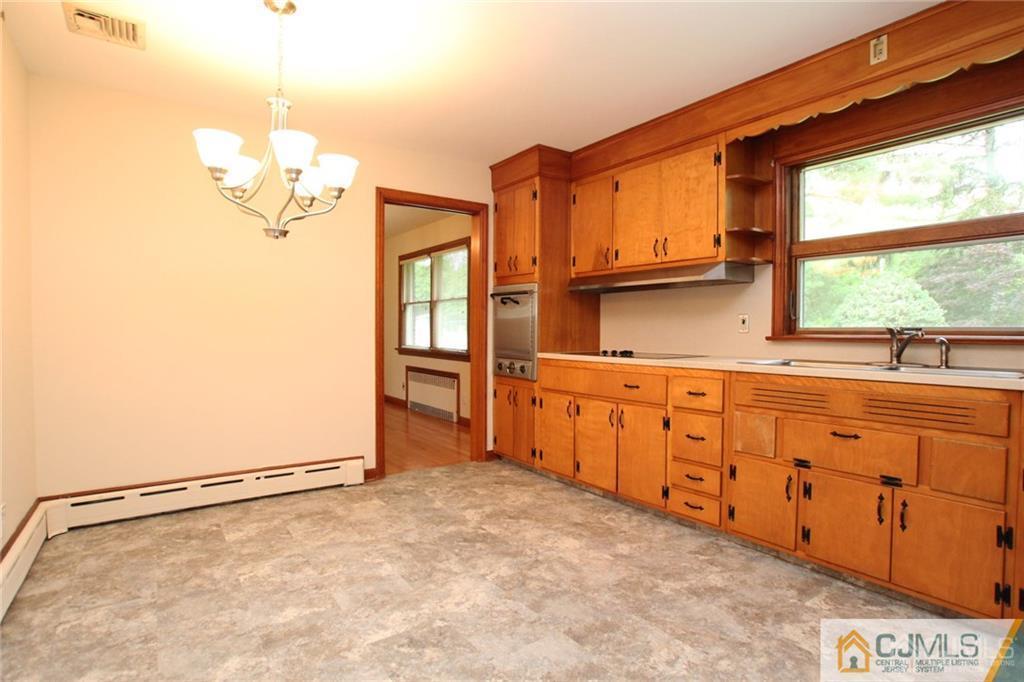 25 Academy Road Somerset, NJ 08873 - Photo 11 of 25 a kitchen with granite countertop a refrigerator and a sink