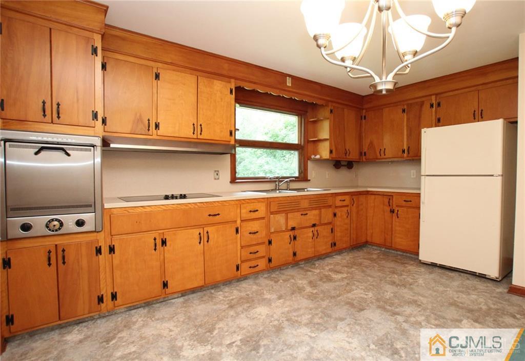 25 Academy Road Somerset, NJ 08873 - Photo 12 of 25 a kitchen with granite countertop a refrigerator and a sink