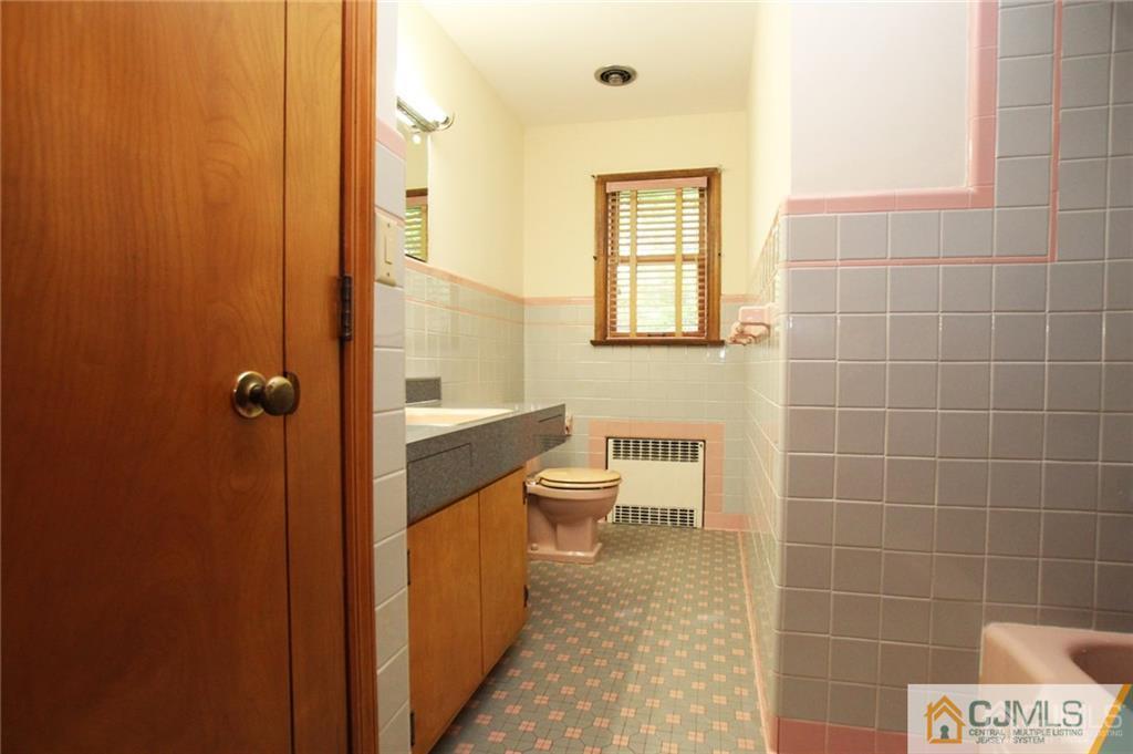 25 Academy Road Somerset, NJ 08873 - Photo 14 of 25 a bathroom with a toilet a sink and shower