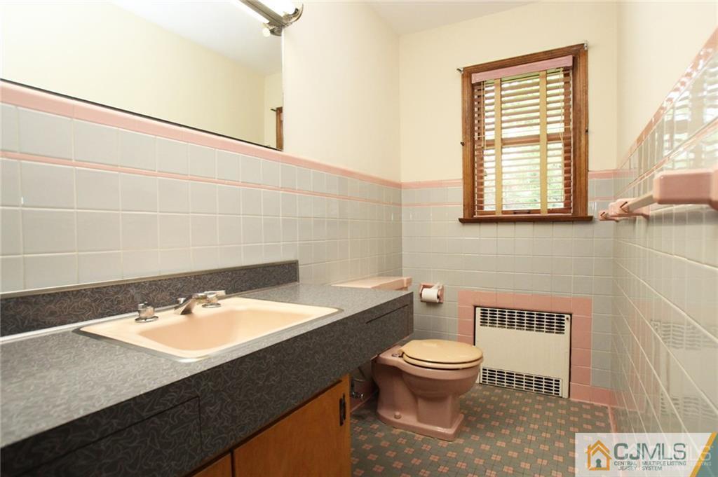 25 Academy Road Somerset, NJ 08873 - Photo 15 of 25 a bathroom with a sink a toilet and a window
