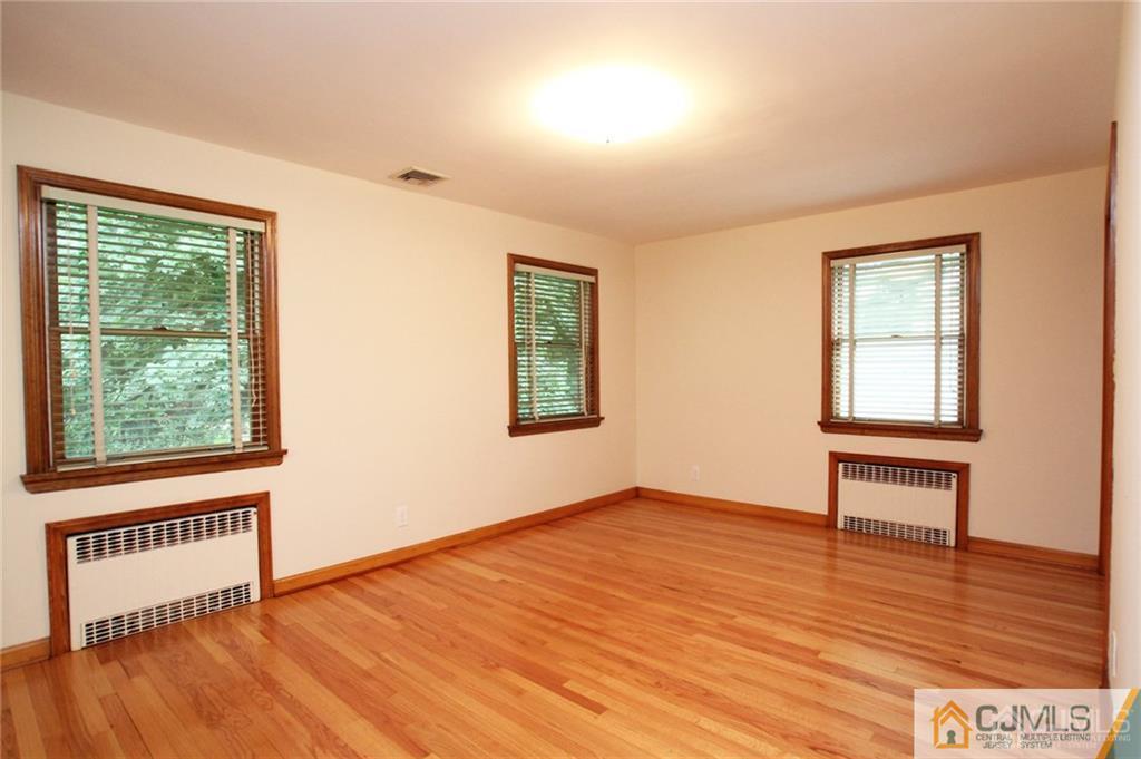 25 Academy Road Somerset, NJ 08873 - Photo 16 of 25 a view of an empty room with wooden floor and a window