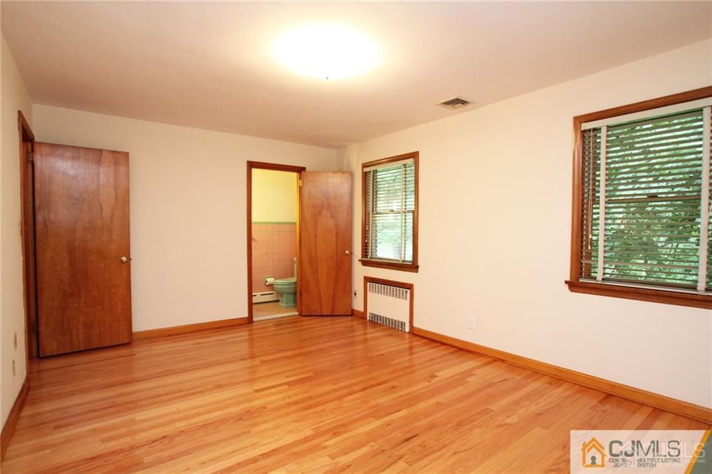 25 Academy Road Somerset, NJ 08873 - Photo 17 of 25 a view of an empty room with wooden floor and a window