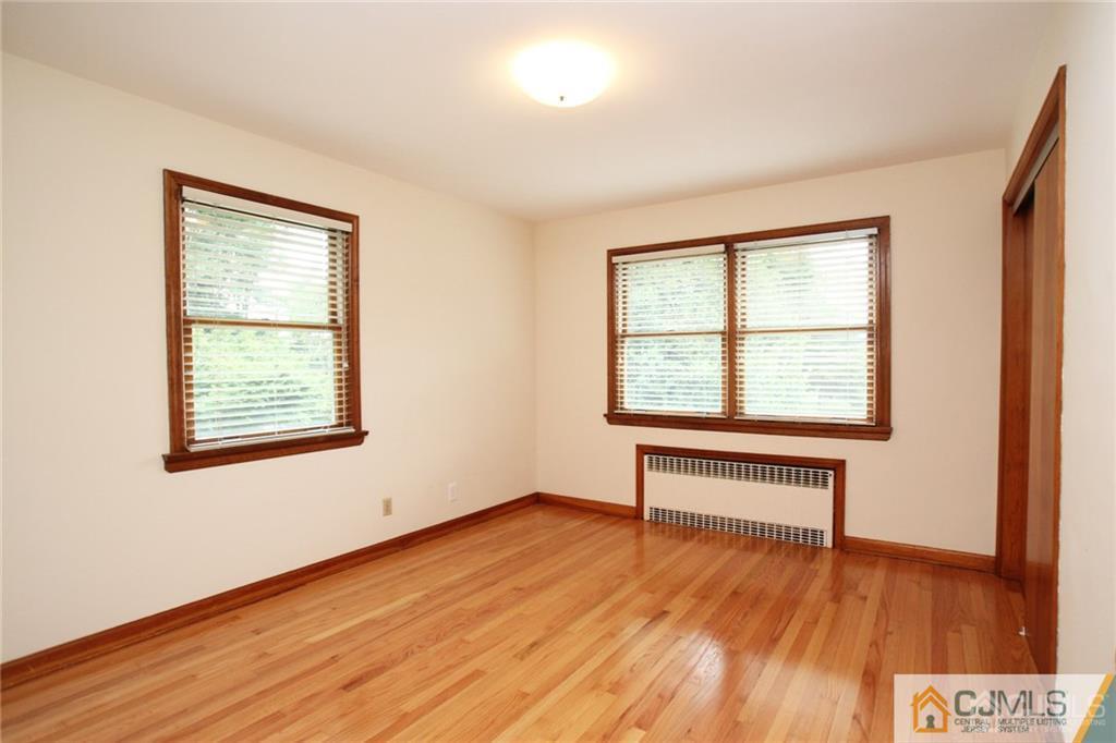 25 Academy Road Somerset, NJ 08873 - Photo 20 of 25 a view of an empty room with wooden floor and a window