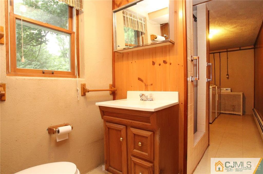 25 Academy Road Somerset, NJ 08873 - Photo 21 of 25 a bathroom with a sink a toilet and shower