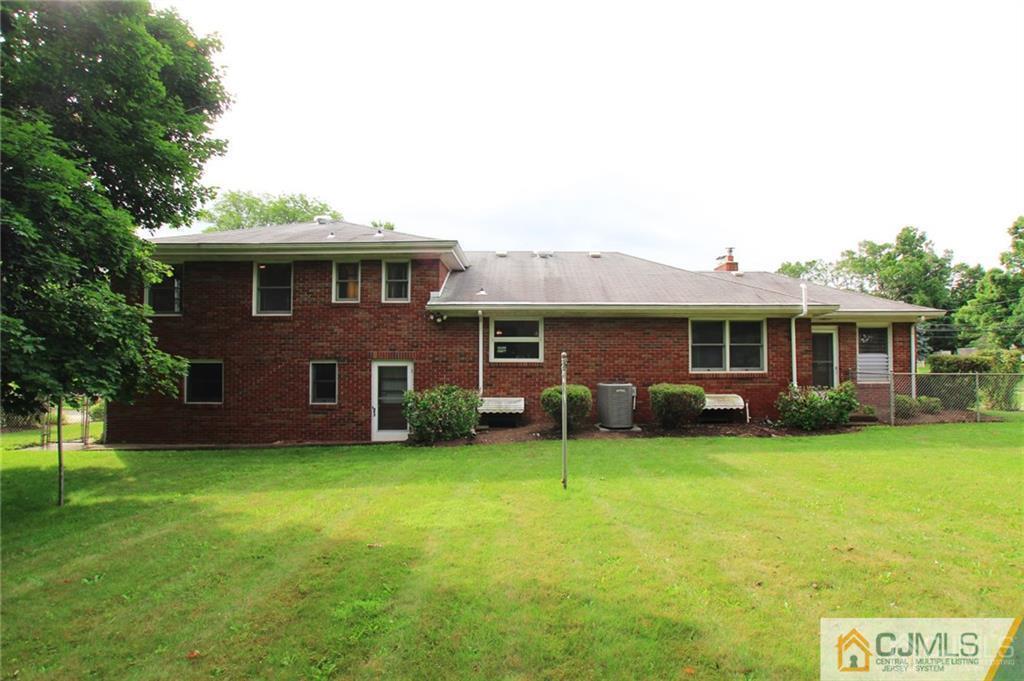 25 Academy Road Somerset, NJ 08873 - Photo 4 of 25 a front view of a house with a garden and trees