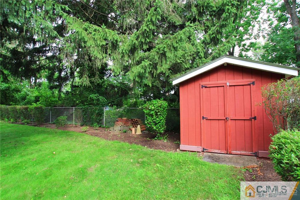 25 Academy Road Somerset, NJ 08873 - Photo 5 of 25 a backyard of a house with wooden fence