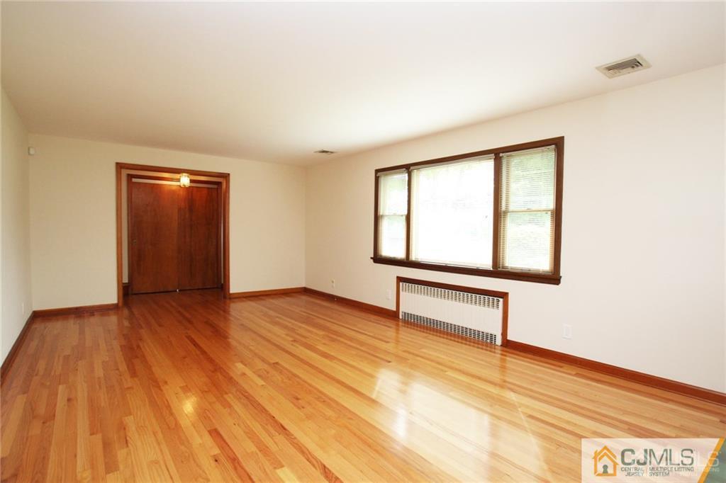 25 Academy Road Somerset, NJ 08873 - Photo 7 of 25 an empty room with wooden floor and windows