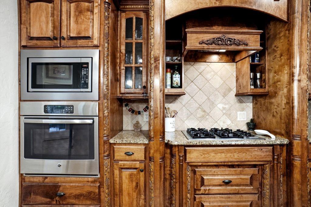 620 Highview Lane Hurst, TX 76054 - Photo 22 of 40 a kitchen with a stove and white cabinets