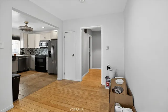 a bedroom with a bed and a refrigerator