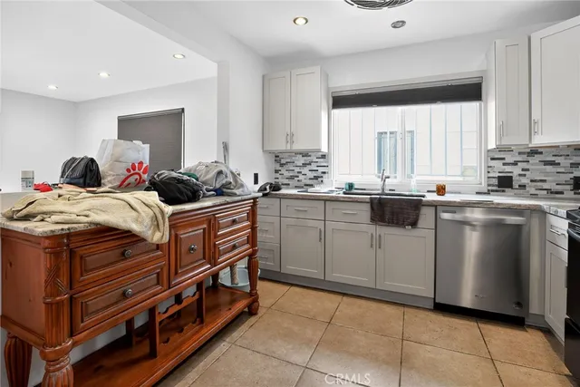 a kitchen with a stove sink and cabinets