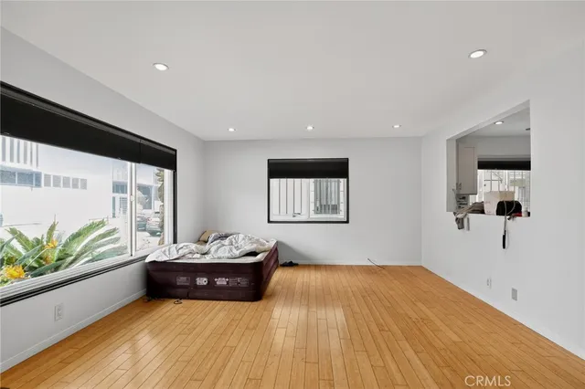 a living room with a couch and a potted plant