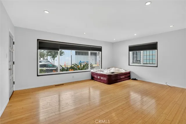 a spacious bedroom with a bed and a large window