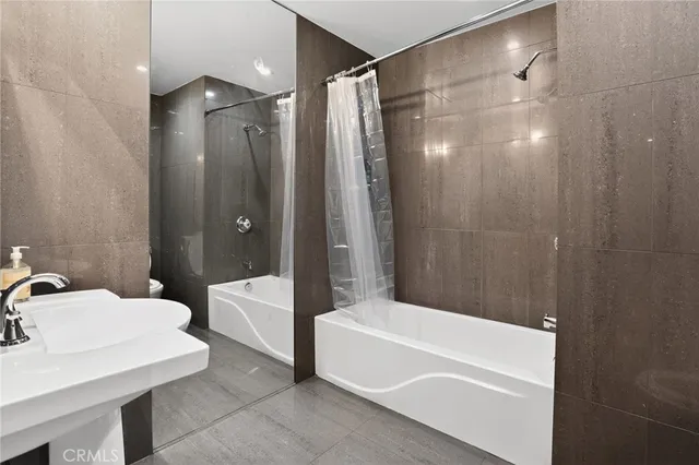 a bathroom with a bathtub a sink and a shower