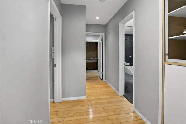 a view of a hallway with wooden floor