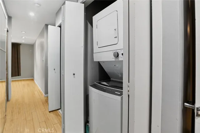 a view of hallway with stainless steel appliances and cabinets