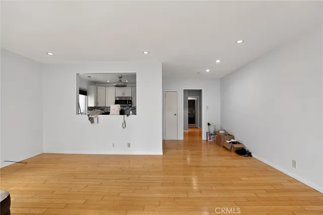 a view of kitchen and hall with wooden floor