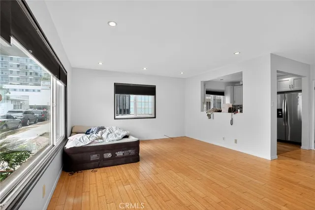 a bedroom with a bed and a large window