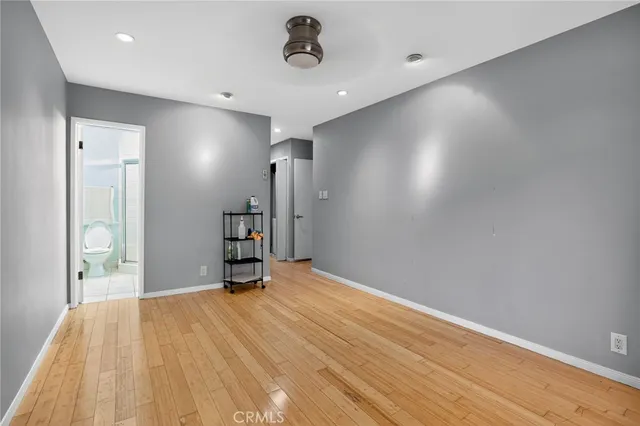 a room with a wooden floor and a window