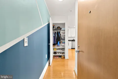 a view of a hallway with wooden floor and staircase