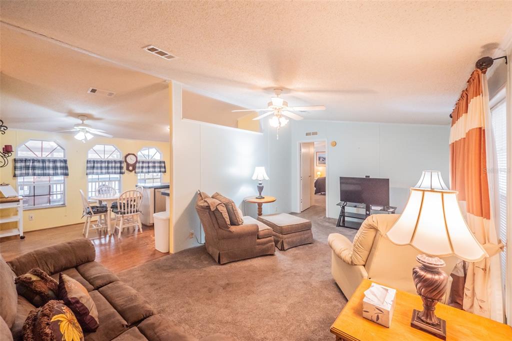 37510 Quail Ridge Circle Leesburg, FL 34788 - Photo 12 of 43 a living room with furniture and a large window