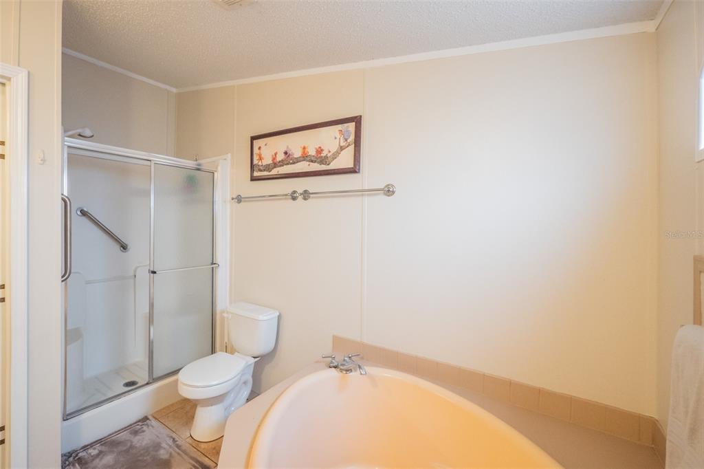37510 Quail Ridge Circle Leesburg, FL 34788 - Photo 28 of 43 a bathroom with a toilet and a shower