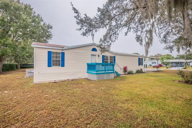 a front view of house with yard and trees
