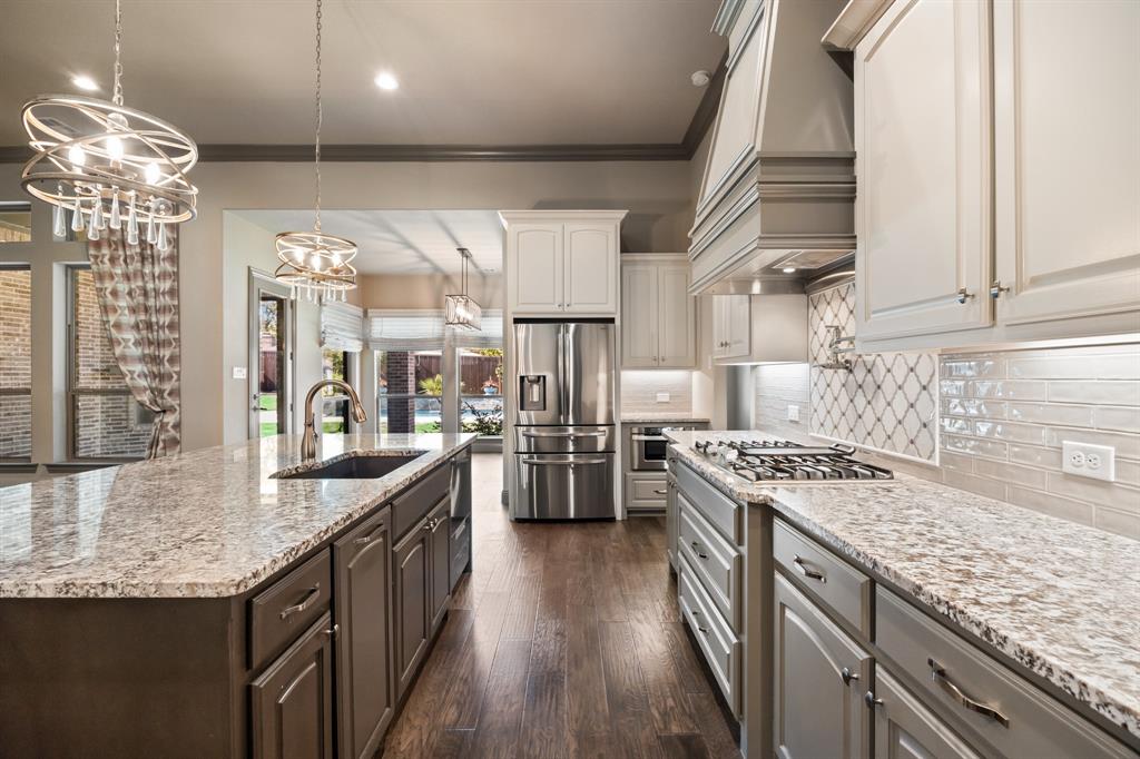 326 Prairie View Road Rockwall, TX 75087 - Photo 13 of 40 a kitchen with stainless steel appliances granite countertop lots of counter top space a stove a sink dishwasher and cabinets