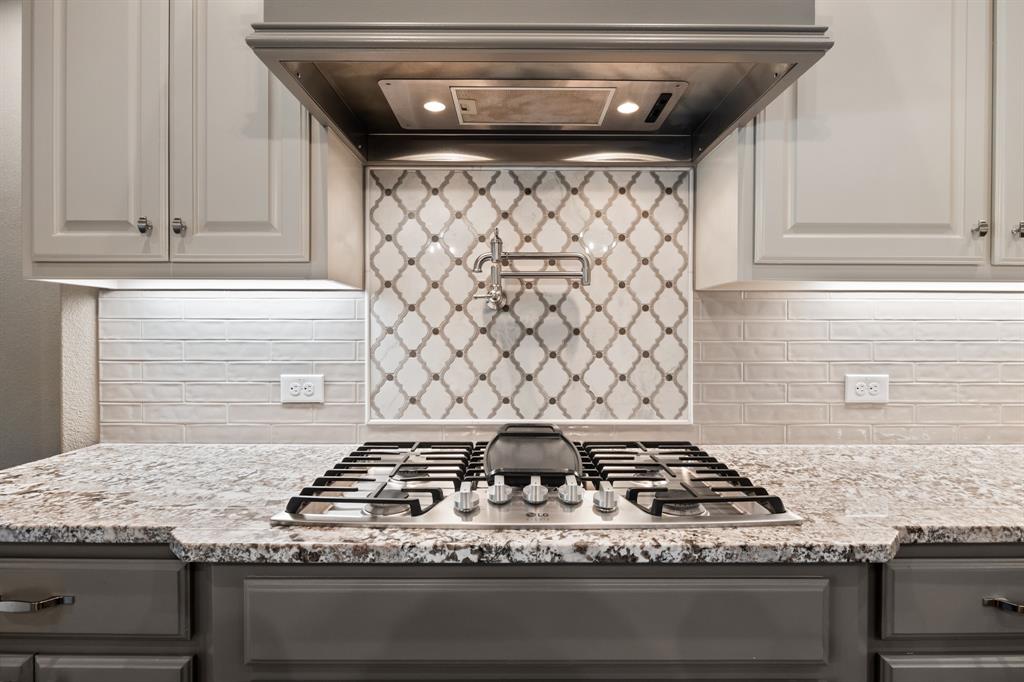 326 Prairie View Road Rockwall, TX 75087 - Photo 14 of 40 a stove top oven sitting inside of a kitchen