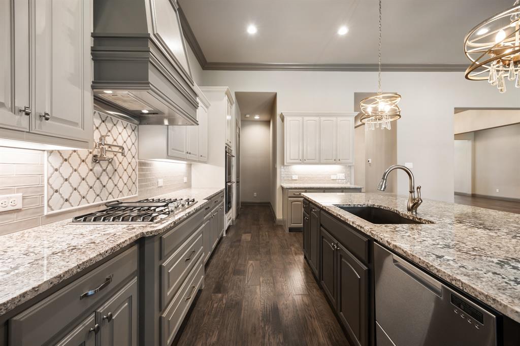 326 Prairie View Road Rockwall, TX 75087 - Photo 15 of 40 a kitchen with stainless steel appliances granite countertop a sink and stove