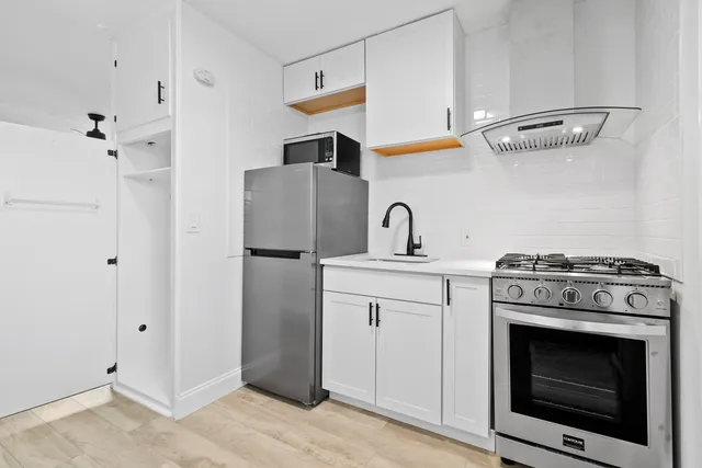 a kitchen with a stove and a refrigerator