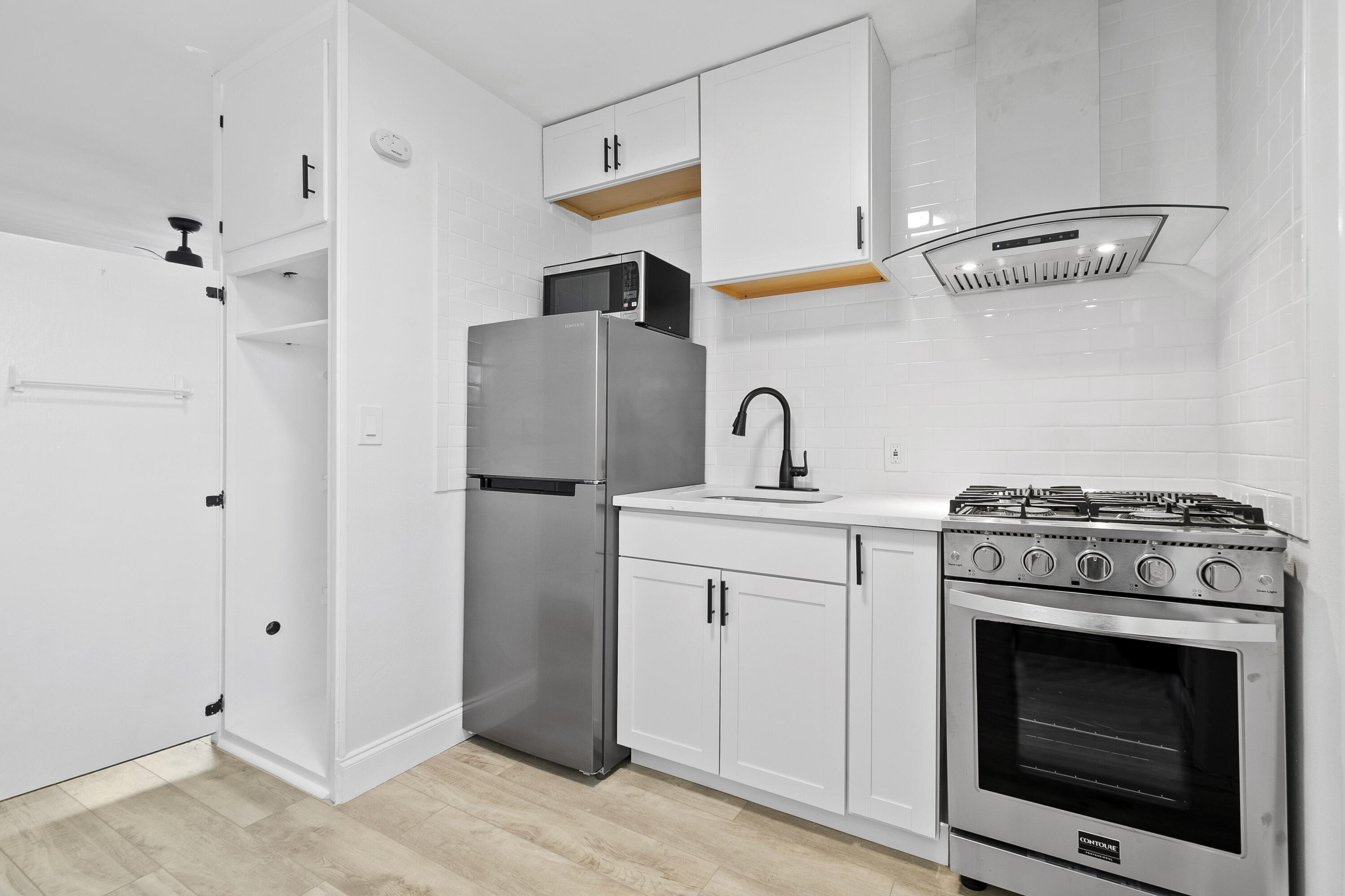 1115 South Ocean Drive, Unit 1 Fort Pierce, FL 34949 - Photo 13 of 48 a kitchen with a stove and a refrigerator