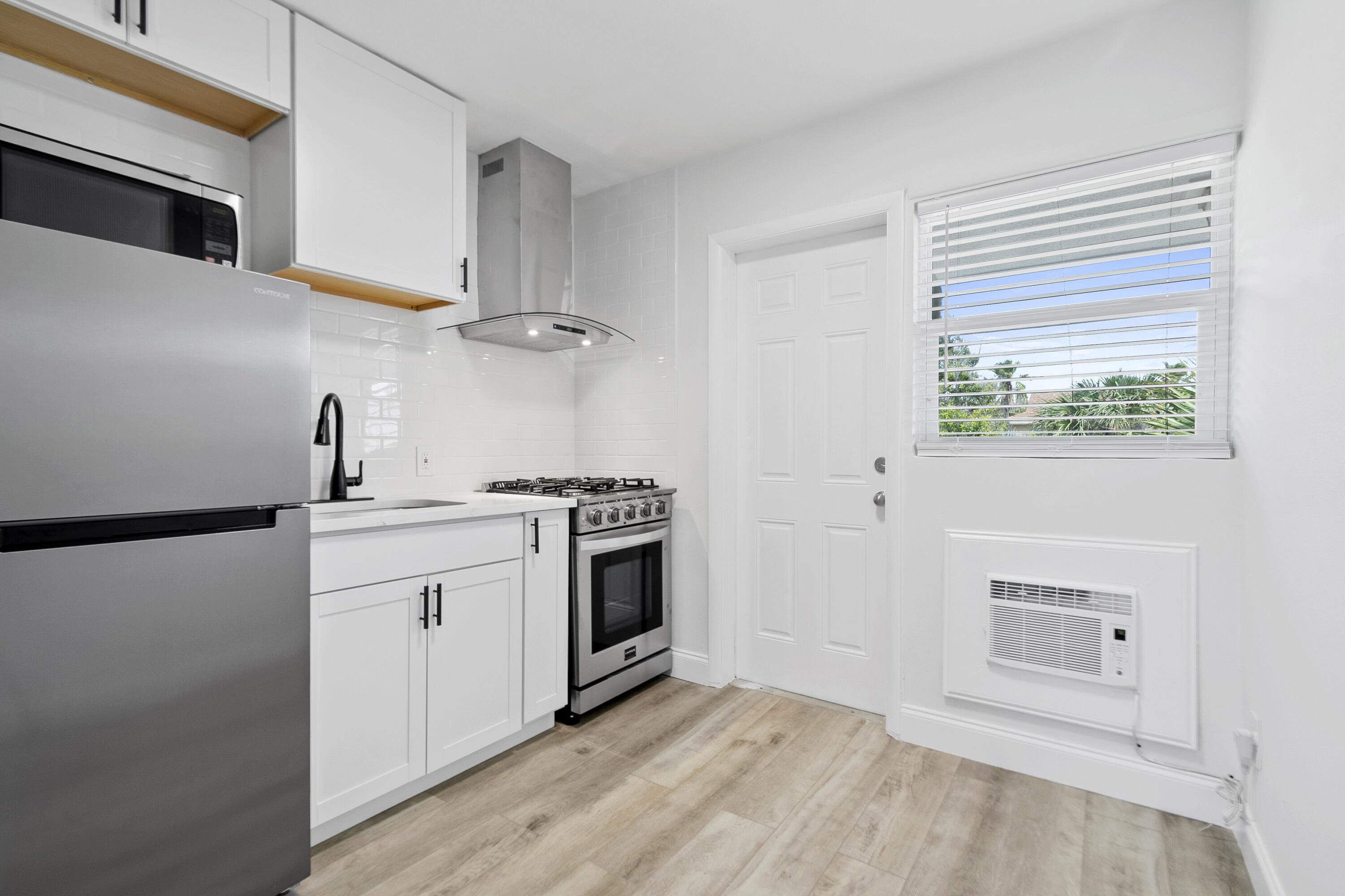 1115 South Ocean Drive, Unit 1 Fort Pierce, FL 34949 - Photo 15 of 48 a kitchen with stainless steel appliances white cabinets and a sink