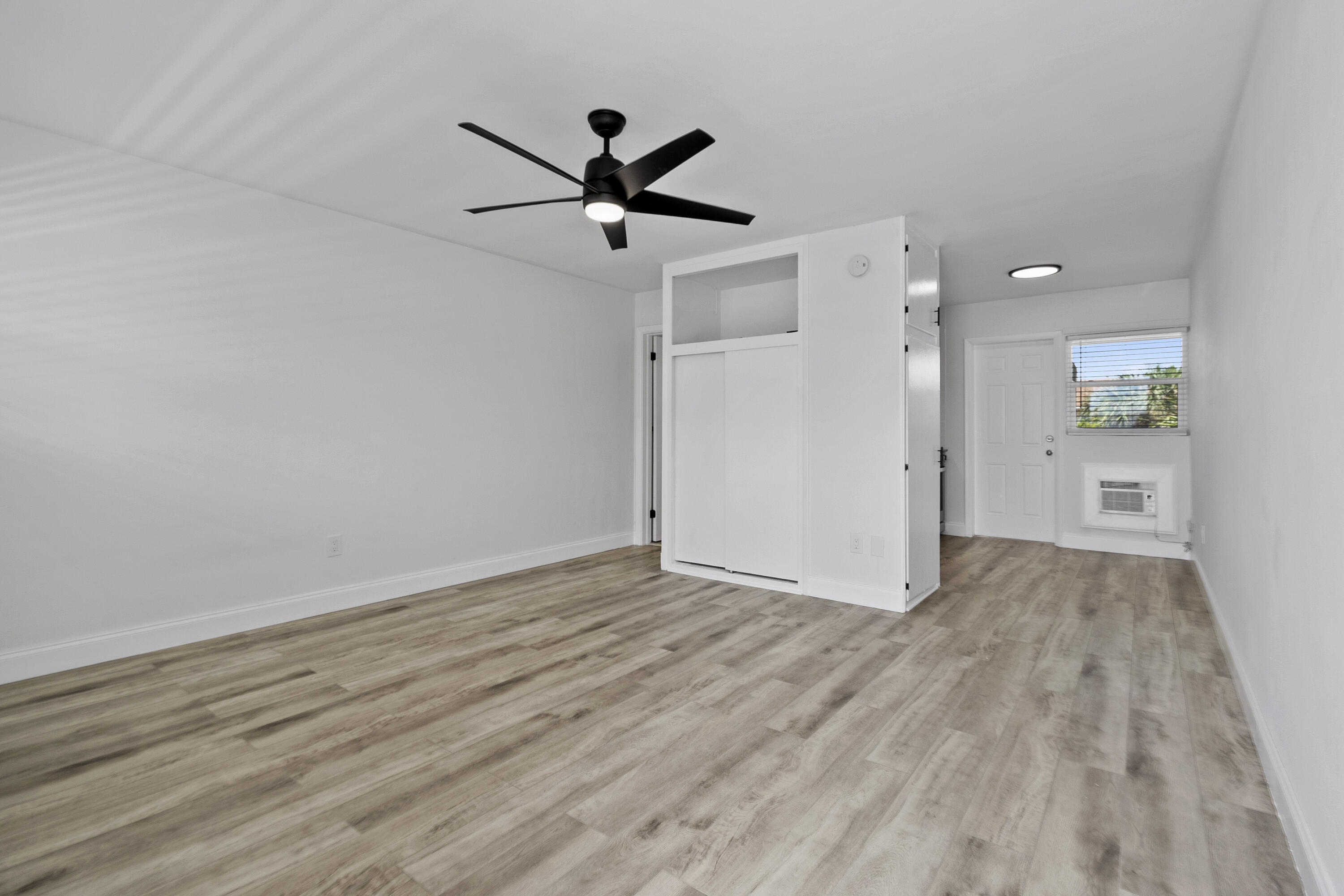 1115 South Ocean Drive, Unit 1 Fort Pierce, FL 34949 - Photo 16 of 48 a view of a big room with wooden floor a ceiling fan and closet area