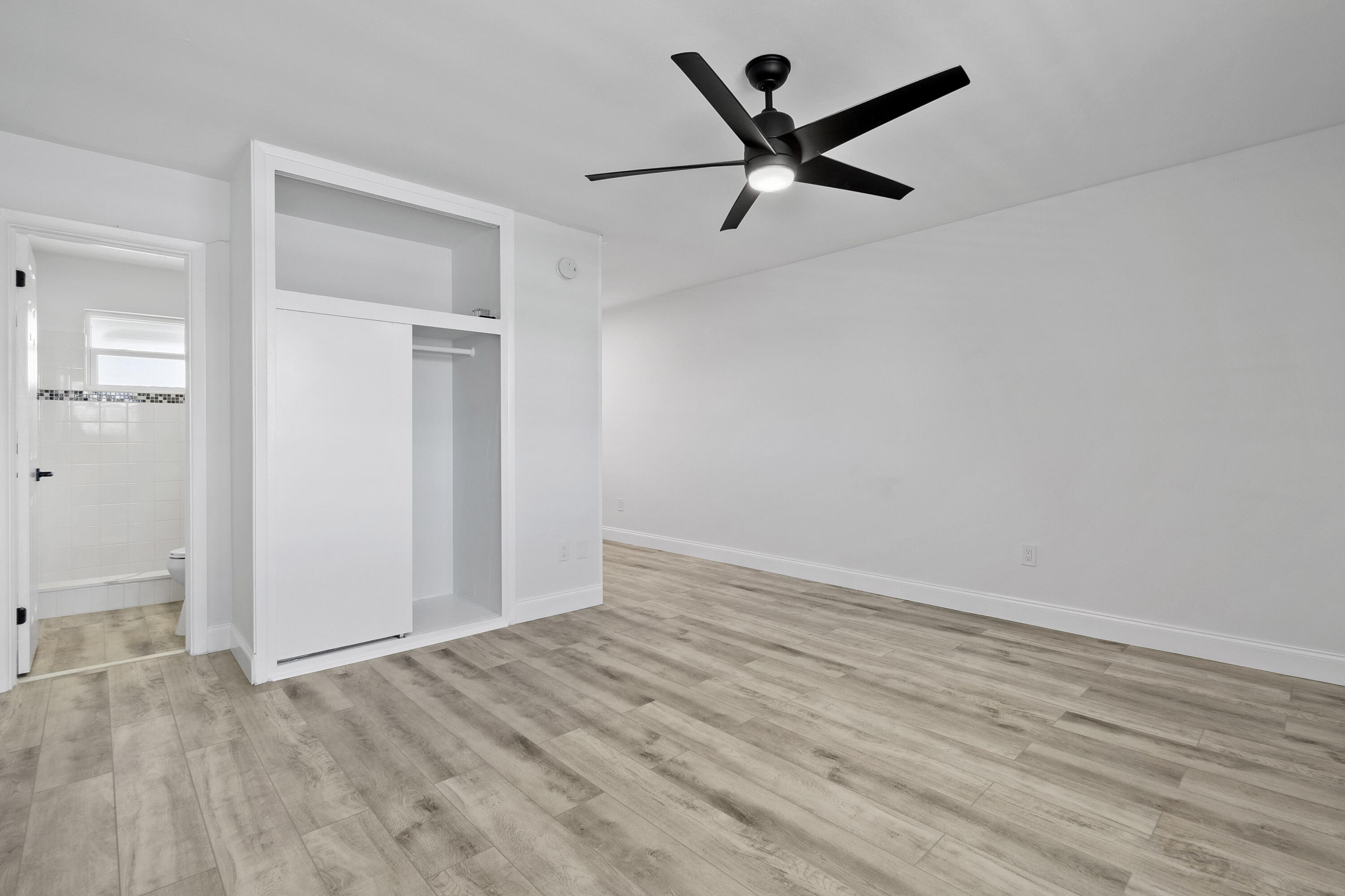 1115 South Ocean Drive, Unit 1 Fort Pierce, FL 34949 - Photo 18 of 48 an empty room with wooden floor and windows