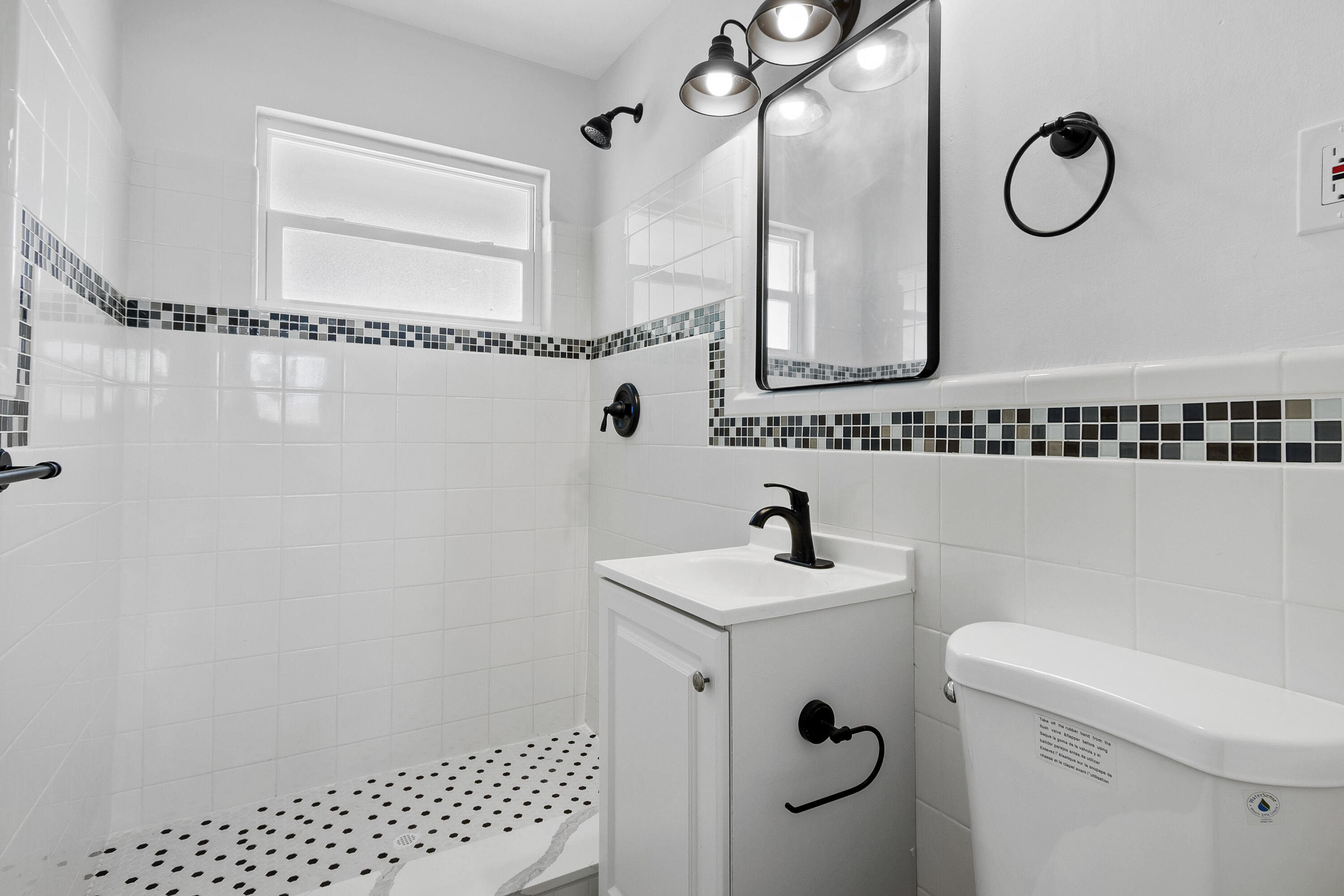 1115 South Ocean Drive, Unit 1 Fort Pierce, FL 34949 - Photo 19 of 48 a bathroom with a sink a toilet and a mirror