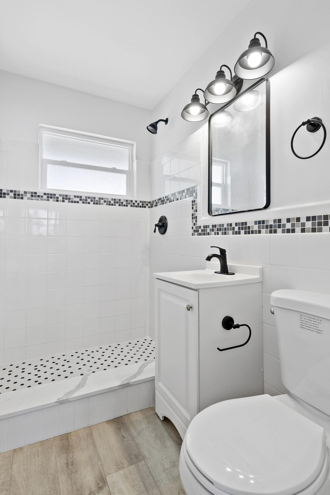 1115 South Ocean Drive, Unit 1 Fort Pierce, FL 34949 - Photo 20 of 48 a bathroom with a sink a toilet a mirror and shower