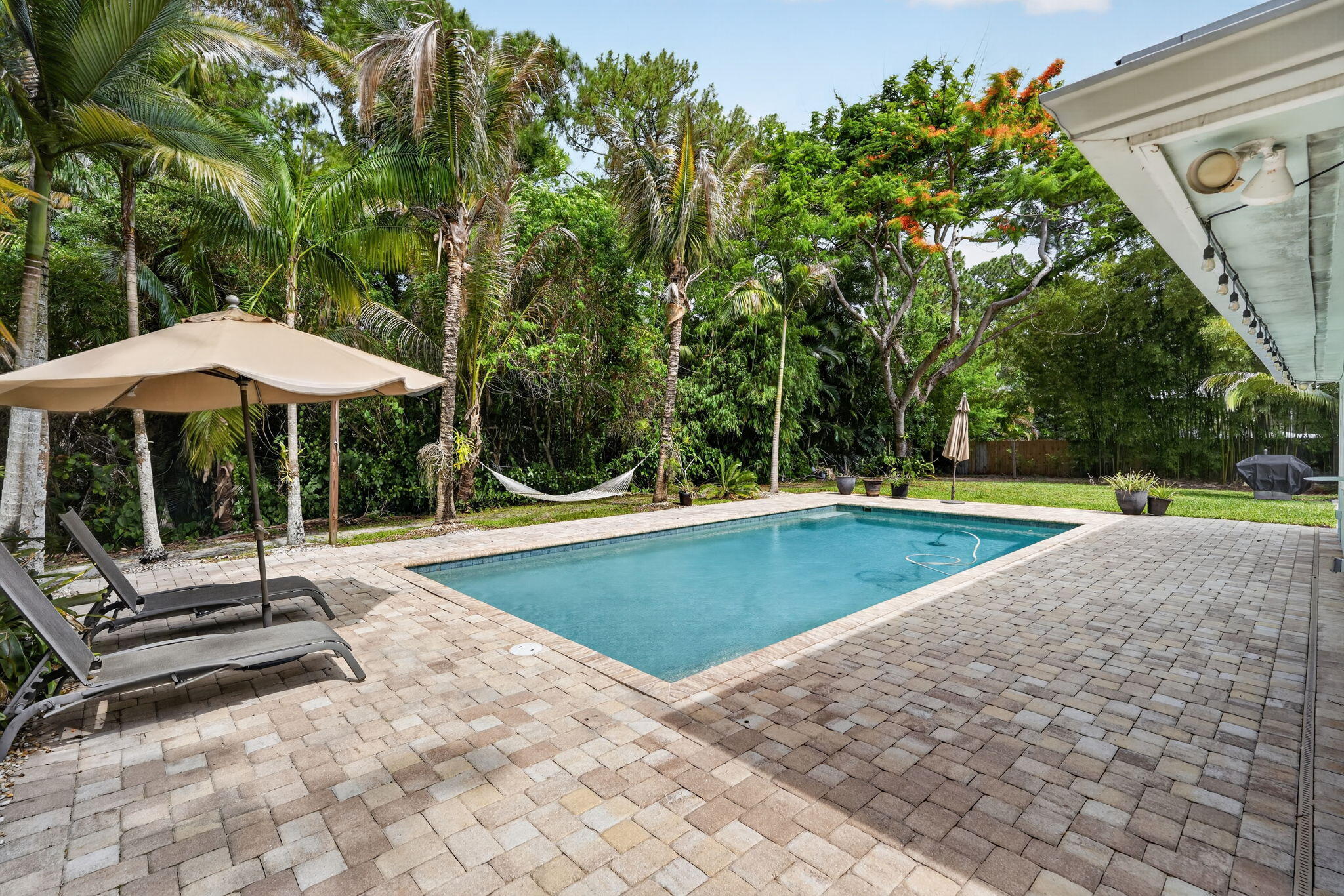 17391 Alexander Run Jupiter, FL 33478 - Photo 36 of 55 a view of pool with two chairs and a table