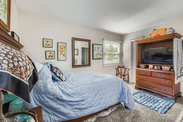 a bathroom with a granite countertop toilet sink and mirror