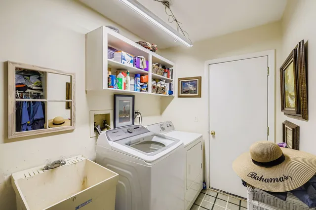 a living room with furniture a bookshelf and a window