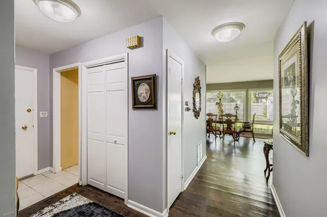 a living room with furniture a wooden floor and a floor to ceiling window