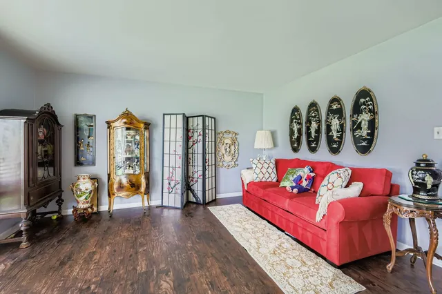 a dining room with furniture and wooden floor