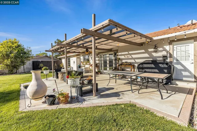 a kitchen with a stove a refrigerator and a dining table
